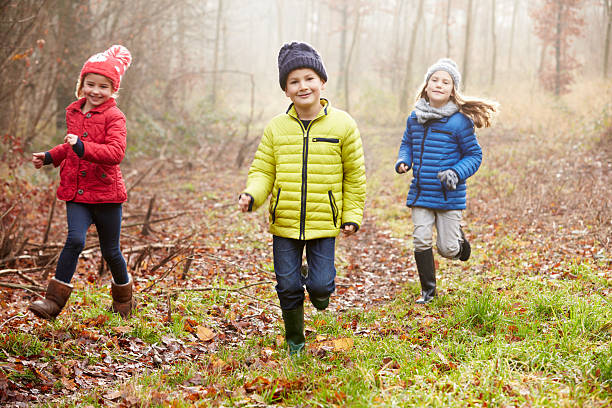 istock Three Children Running Through Winter Woodland 505617897