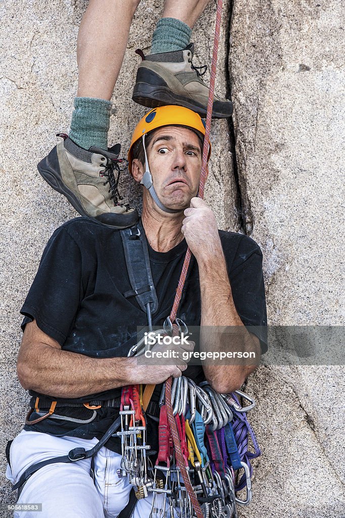 Taking the first step. Climbing team taking the first step. A Helping Hand Stock Photo