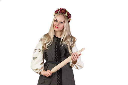 Beautiful woman in ukrainian national traditional costume with rolling pin - isolated on white