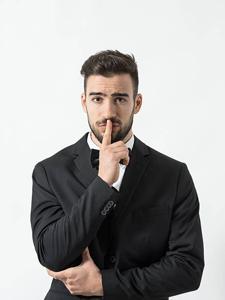istock Portrait of young scared man with finger over his lips 505619216