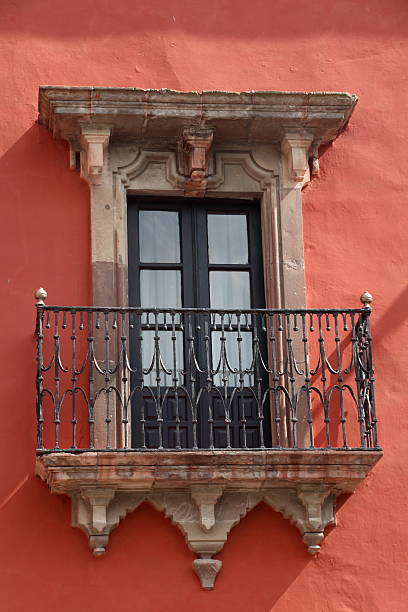 istock Window with balcony and red wall 505619567
