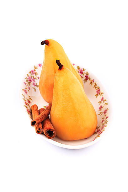 istock Poached pears in syrop with cinnamon isolated 505620271