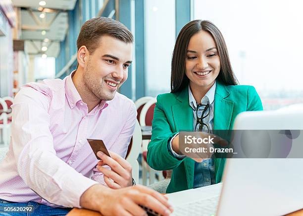 Young Couple Buying New Items On Internet Auctions And Smiling Stock Photo - Download Image Now