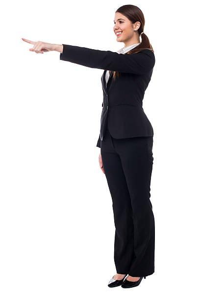 istock Corporate smiling woman pointing at something 505620759