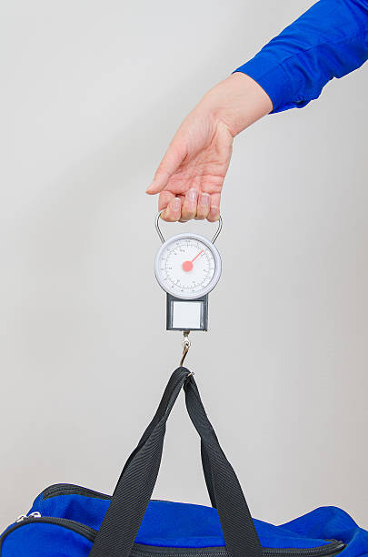 istock Hand luggage measurement using steelyard balance. 505620955