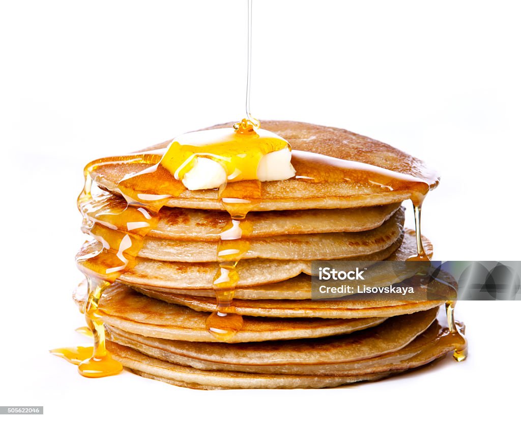 Small pancakes with butter and honey Stack of Small pancakes with butter and honey syrup on white background Pancake Stock Photo