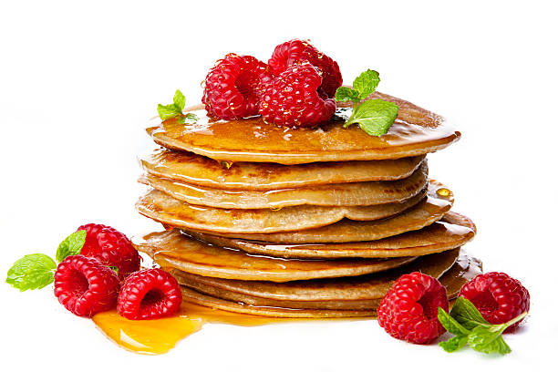 istock Small pancakes topped with honey, raspberries and mint 505622154