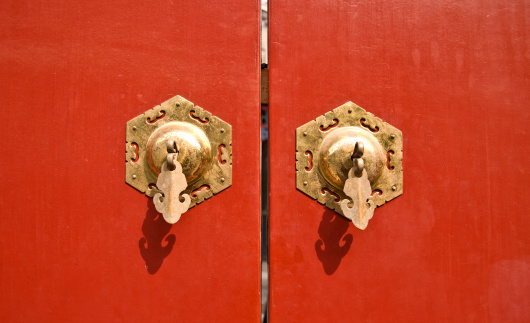 Red chinese antique door with golden handles