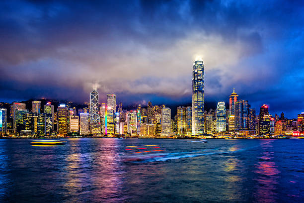 Hong Kong financial district at twilight Hong Kong financial district at twilight, Victoria Harbour, Hong Kong Island. victoria harbour stock pictures, royalty-free photos & images