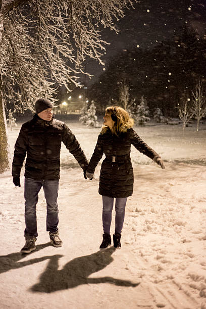 istock Beautiful couple is taking walk on a winter night 505625514