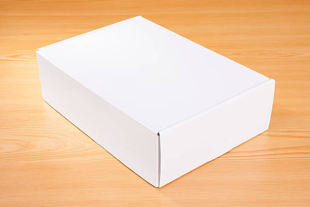 istock Blank white box on wood background 505628300