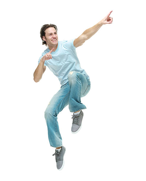 istock Cheerful casual man jumping and pointing away 505628570