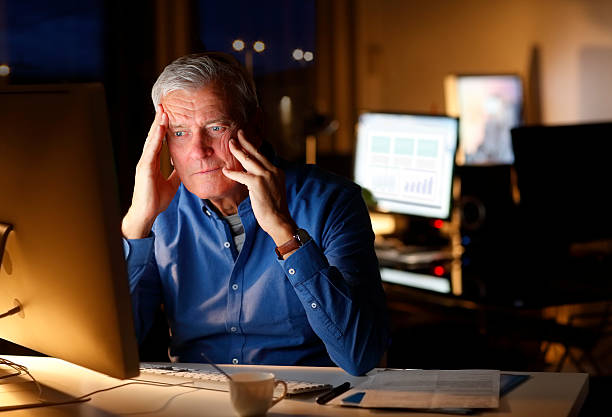 istock Exhausted businessman working late night 505628894