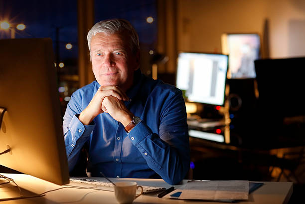 istock Senior businessman working late 505628962