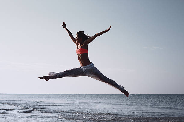 istock Woman jumping on sea background 505632491