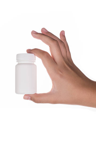 istock Hand holding supplements, medications or vitamins bottle 505634697