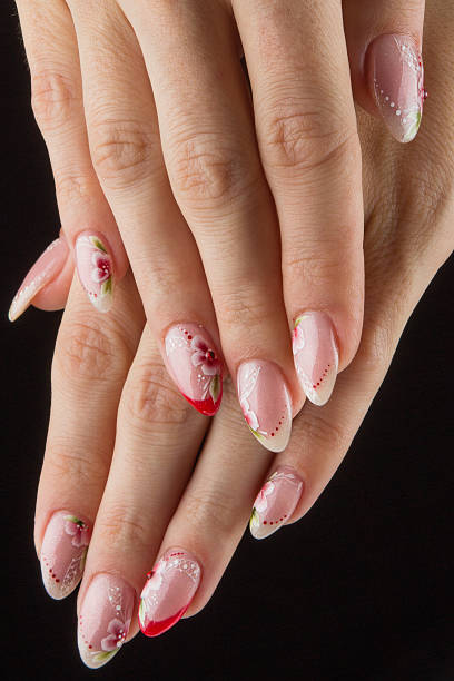 istock painted nails with flowers and hands isolated on black background 505634801