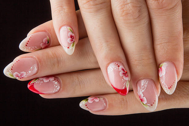 istock painted nails with flowers and hands isolated on black background 505634807