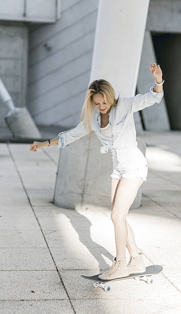 istock beautiful young woman with skateboard 505635995