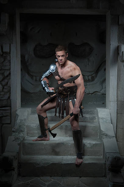 istock Gladiator in armour standing on steps of ancient temple with 505636623