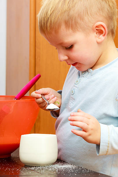 istock Boy kid baking cake. Child holding sugar bowl. Kitchen. 505636771