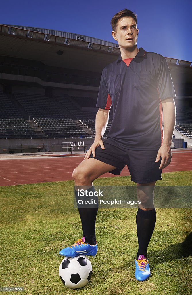 Ready for the next game Shot of a young footballer standing on a field with a ball under his foot Active Lifestyle Stock Photo