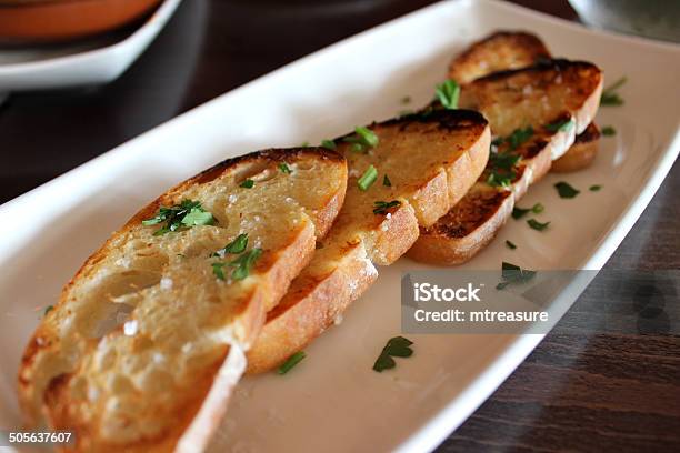 Image Of Garlic Bread Slices Topped With Herbs And Toasted Stock Photo - Download Image Now