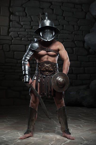 istock Gladiator in helmet and armour holding sword 505638073