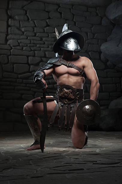 istock Gladiator in helmet and armour holding sword 505638083