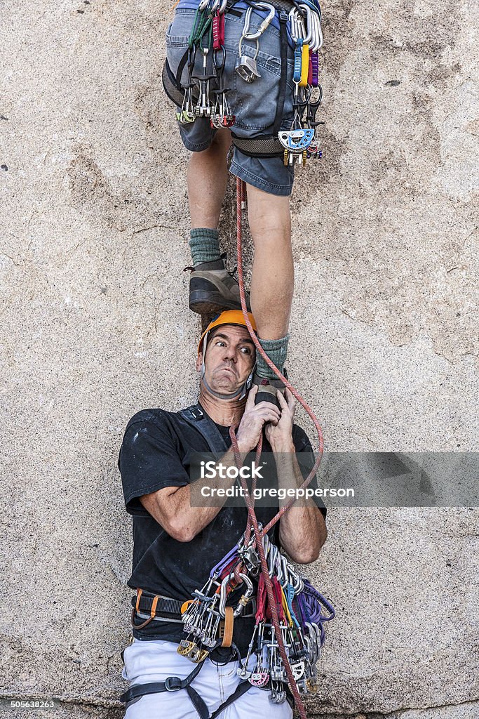 Taking the first step. Climbing team taking the first step. Assistance Stock Photo