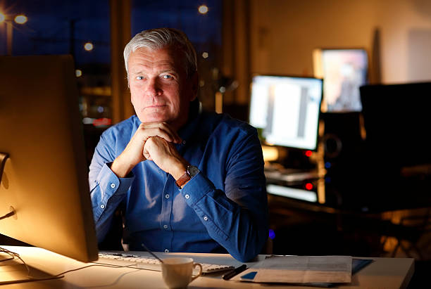 istock Senior businessman working late 505639062