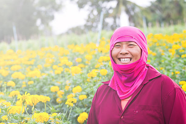istock lady gardening in her farm smiling 505639741