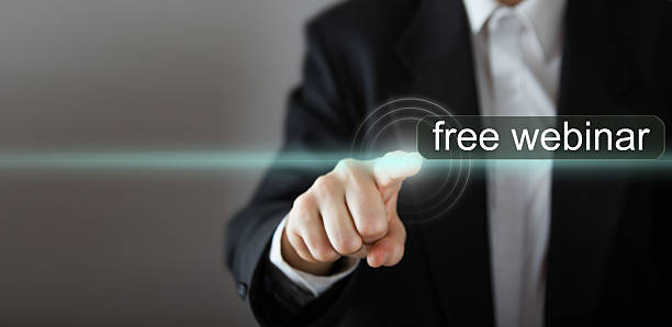 istock free webinar. Businessman's hand pressing the icon with text 505640438