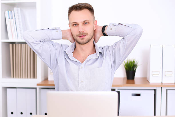 istock Business man sitting at the desk on office background 505640964