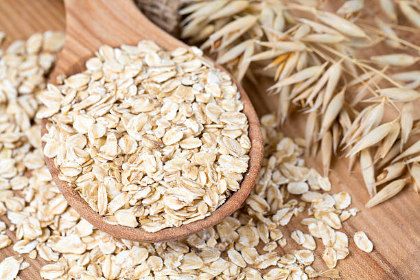 istock oat flakes in a spoon on wooden surface 505641604