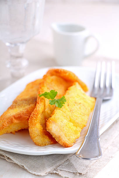 istock fish fillets fried in corn meal on a white plate 505643870