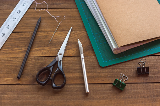 Bookbinding tools on rustic wooden table