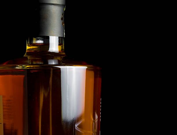 istock whiskey bottle on black background 505645102