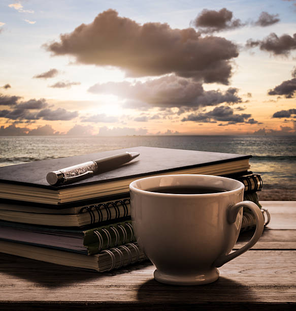istock Coffee break with notebooks and pen on wooden table 505645526