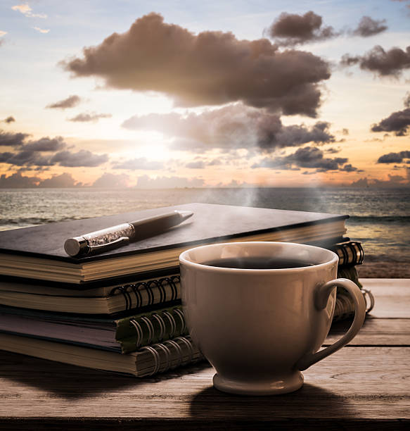 istock Hot coffee with notebooks and pen on wooden table 505645578
