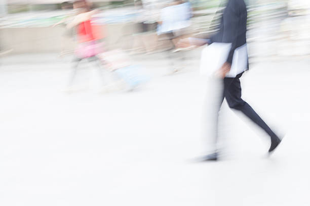 istock motion blur business people walking 505646304