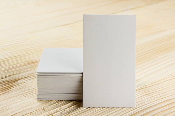 istock White blank business visit card, ticket, pass, present  wooden background 505646356