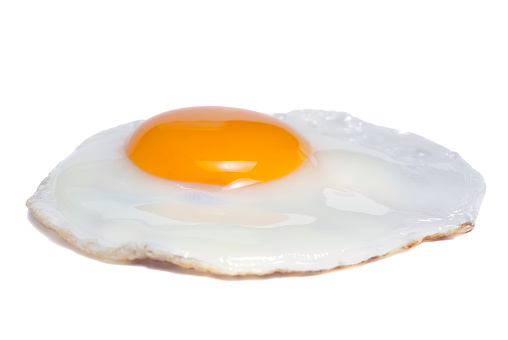 A fried egg, isolated on white.