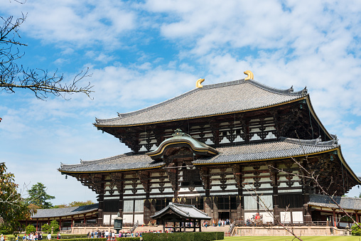 Nara, Japan - October 6, 2015: View of the Daibutsuden (Great Buddha Hall) at Todai-ji (Eastern Great Temple) on a sunny Autumn morning. Tōdai-ji is a Buddhist temple complex located in the city of Nara, Japan. Its Great Buddha Hall houses the world's largest bronze statue of the Buddha Vairocana, known in Japanese simply as Daibutsu. The temple also serves as the Japanese headquarters of the Kegon school of Buddhism. 