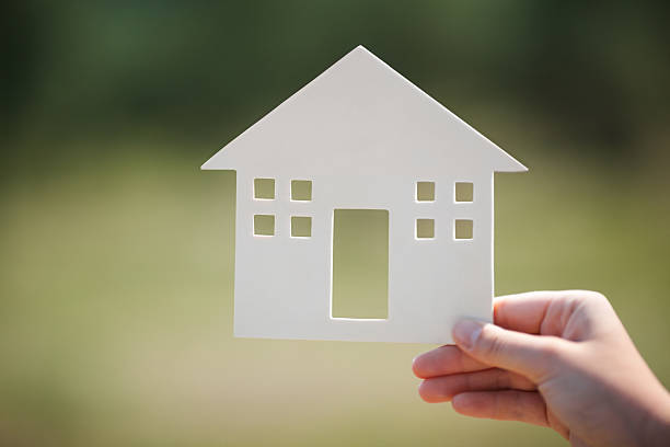 istock Hand holding house model outdoor 505648274