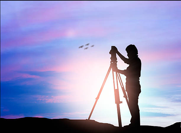 istock silhouette engineer looking Loaders and trucks in a building sit 505648600
