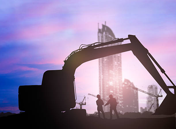istock silhouette Loaders and construction worker in a building site ov 505648728