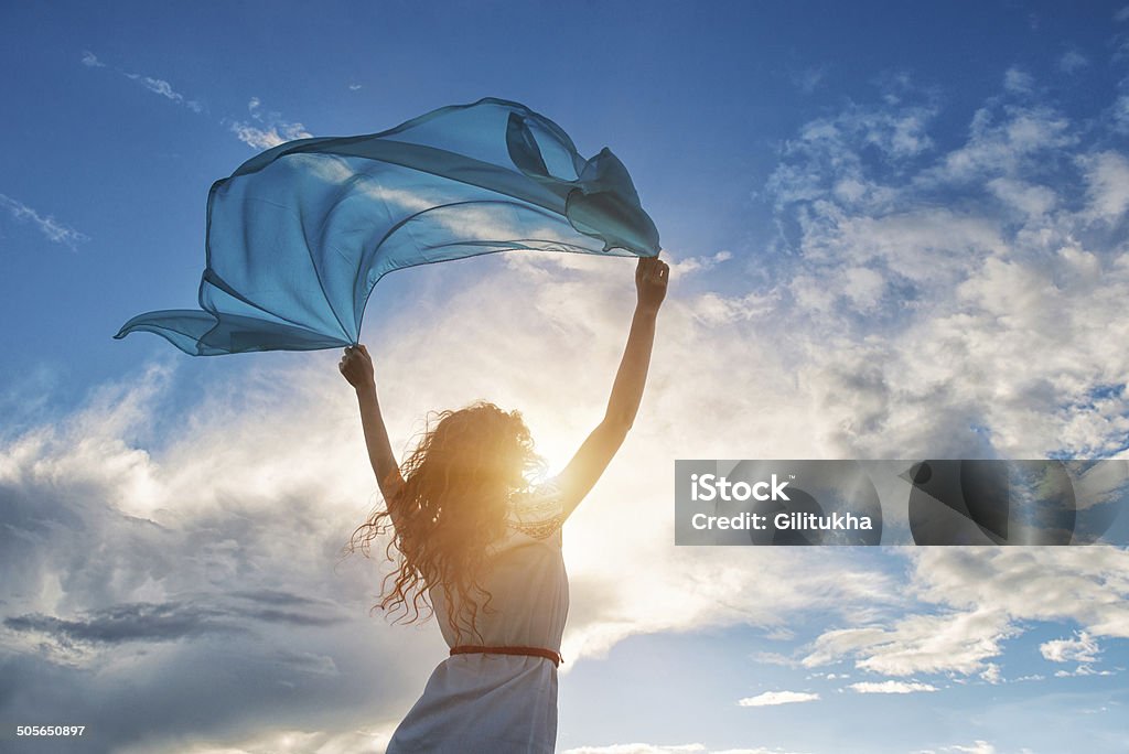 Belle jeune femme tenant écharpe bleue sur le vent - Photo de Femmes libre de droits