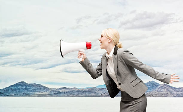istock Smiling businesswoman shouting with megaphone 505651208