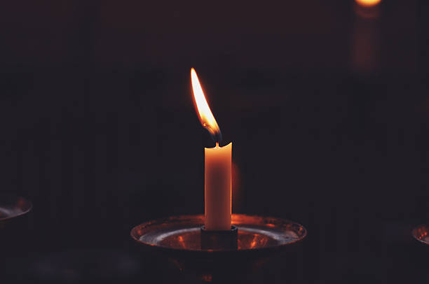 istock One candle flame at church - toned picture 505651408